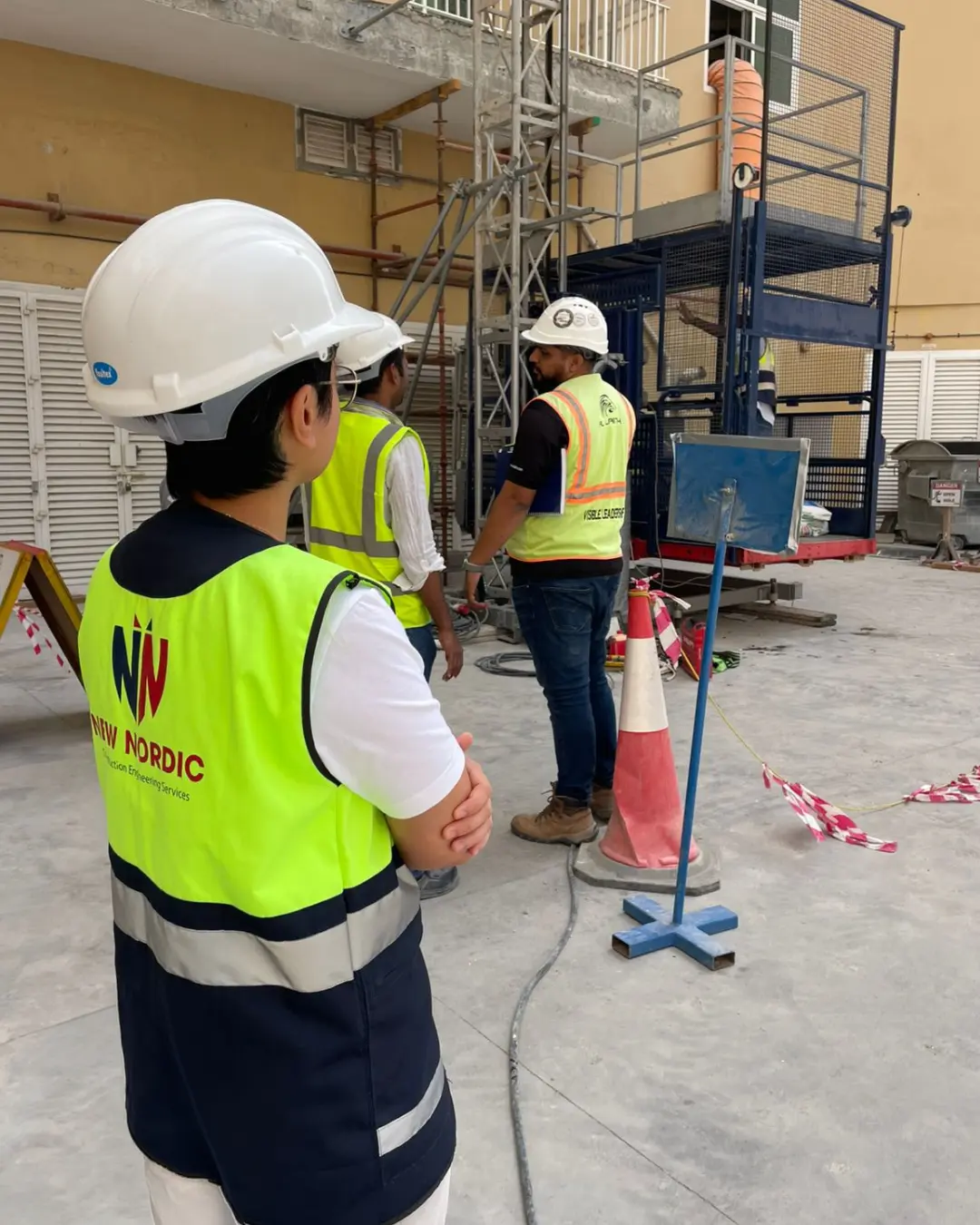 New Nordic engineers supervising structural works on site with scaffolding
