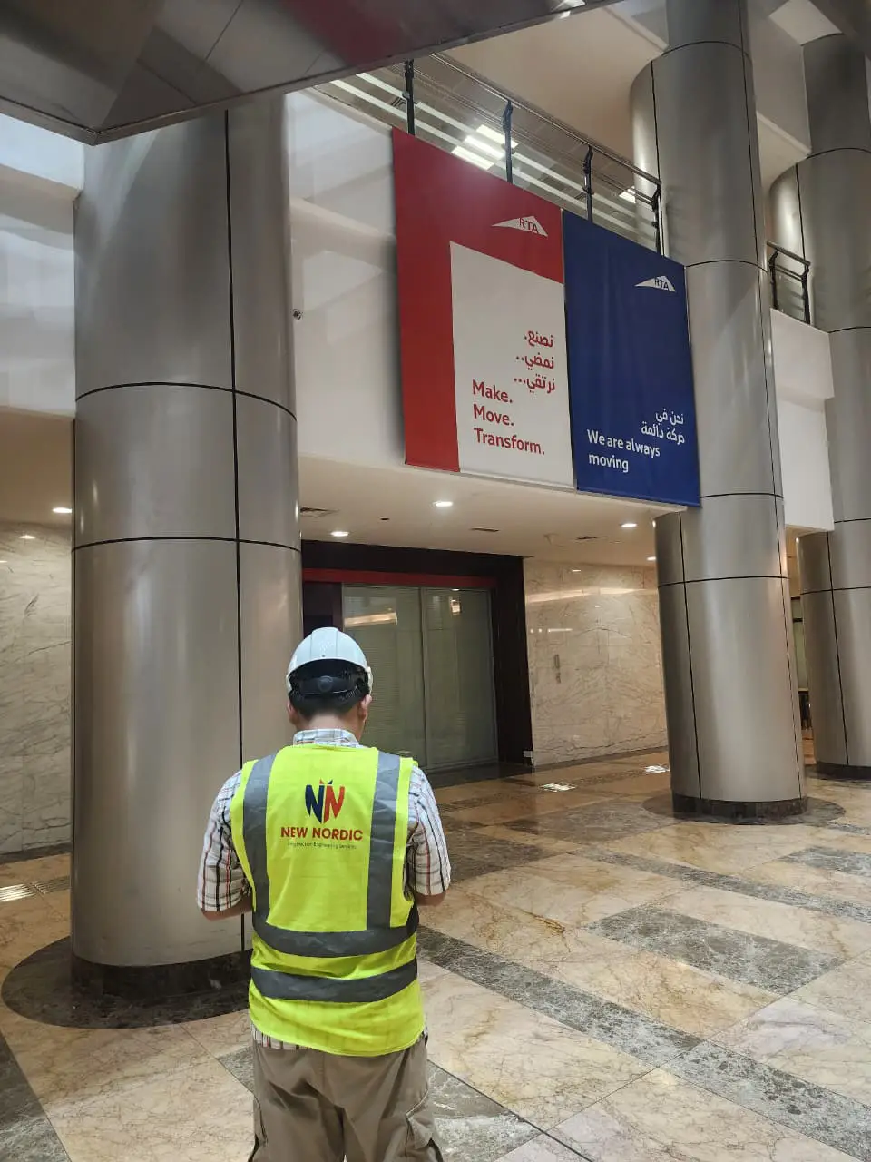 New Nordic engineer surveying a building lobby interior during a reserve fund condition survey