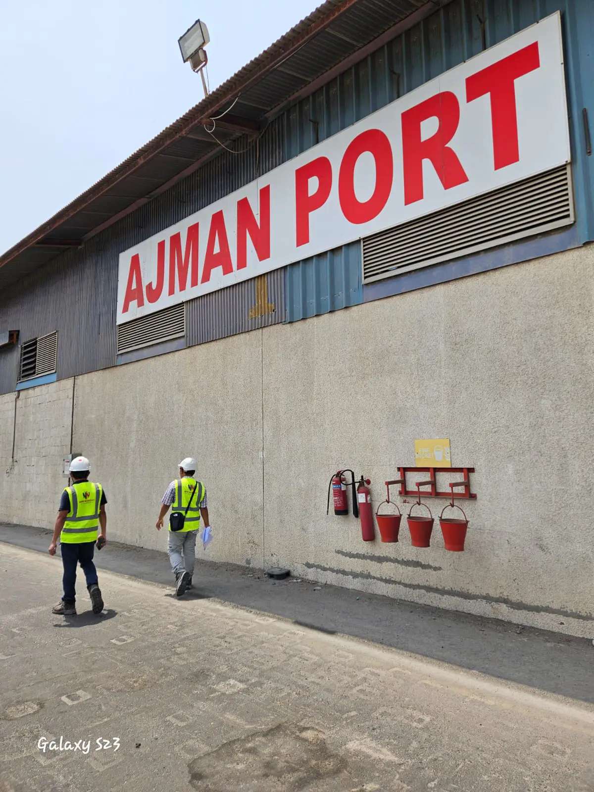 New Nordic engineers walking to a warehouse at Ajman Port during a marine facility inspection